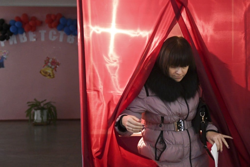A woman exits a polling booth during rebel elections in Donetsk, Ukraine. Photo: AP