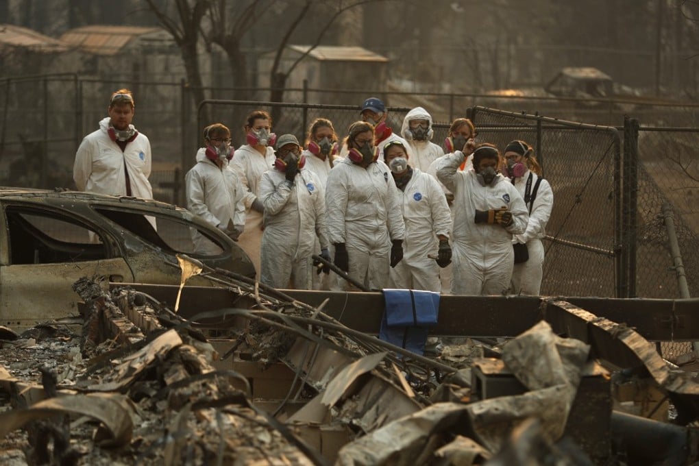 Anthropology students observe as human remains are recovered from a burned out home in Paradise, California, on Sunday. Photo: AP