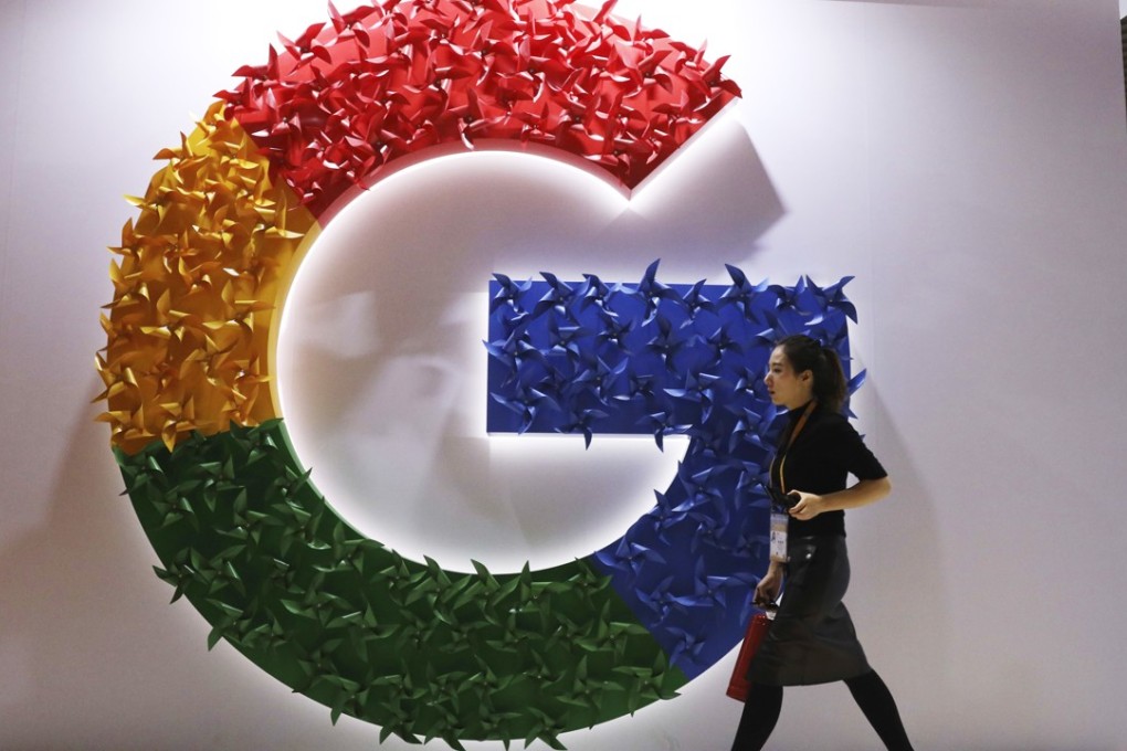 A woman walking past the Google logo at the China International Import Expo in Shanghai on November 5, 2018. Photo: AP