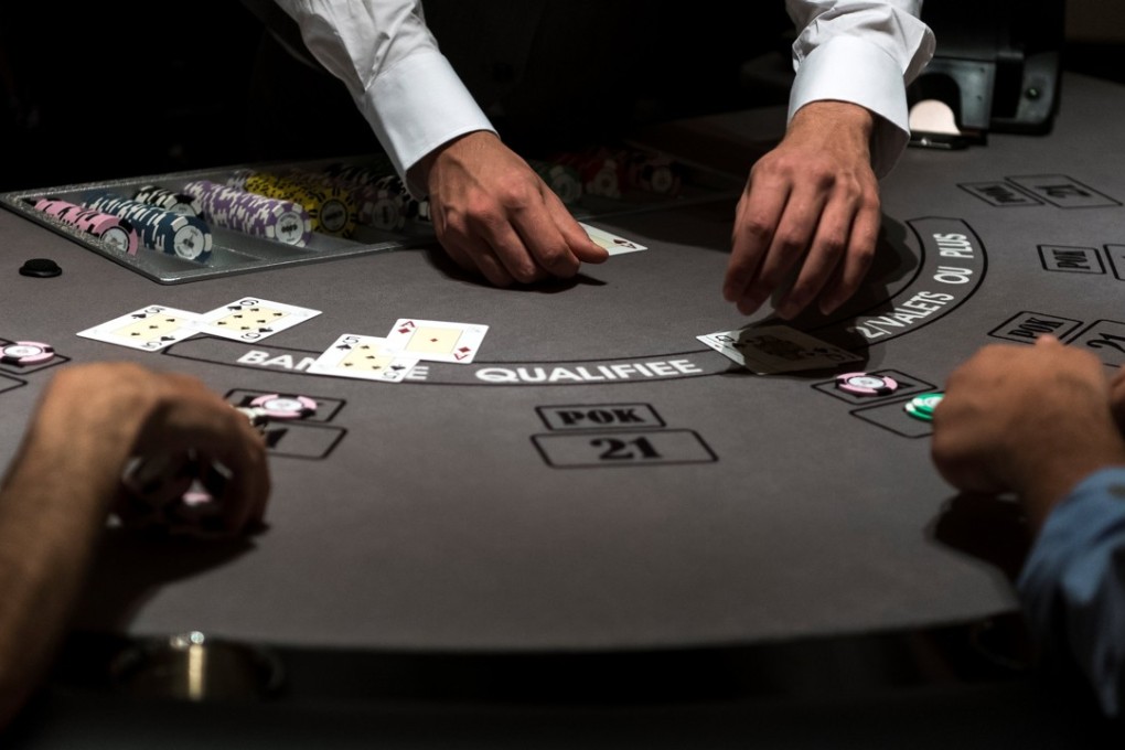 People play a card game at the Paris Elysées Club, the first gaming club to open its doors in Paris. Photo: AFP