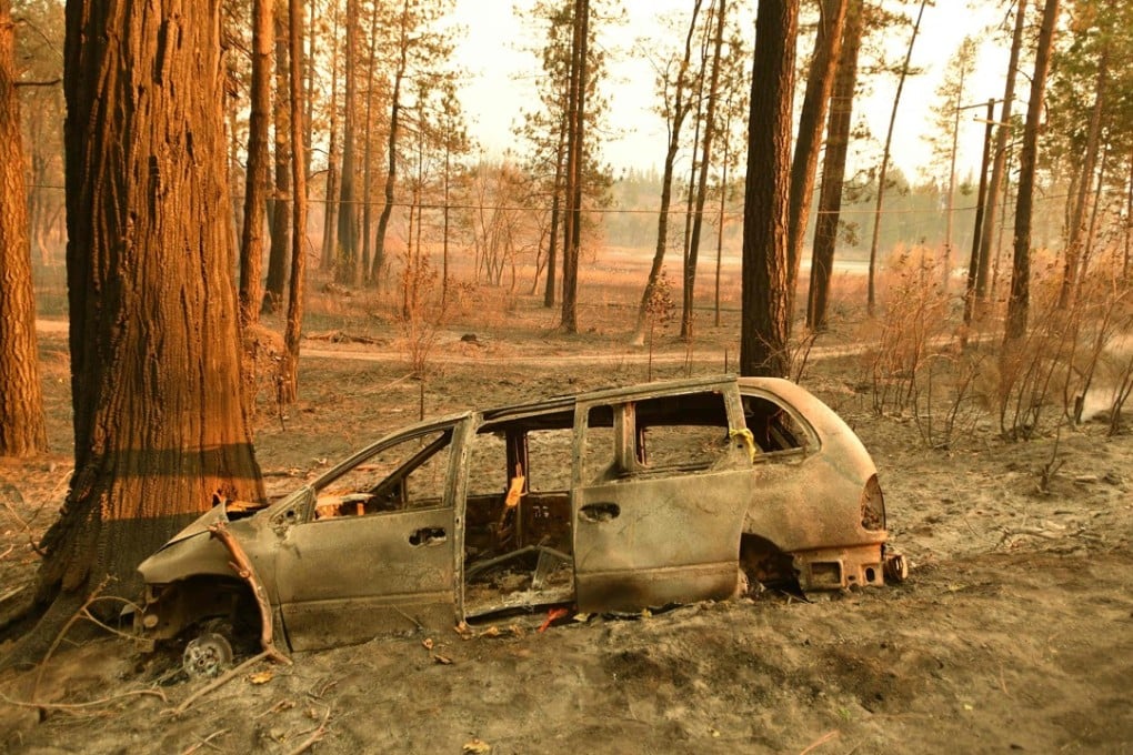 A burned-out vehicle rests against a tree in Concow, California, on November 11, after fire ripped through the area. Three major wildfires are roaring through California. The so-called “Camp Fire” in the north has already destroyed more than 6,700 structures, and is considered the most destructive fire in state history. Photo: AFP