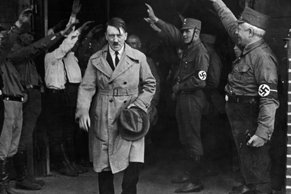 December 1931 photo of Germany’s National Socialists saluting Adolf Hitler as he leaves the party’s Munich headquarters. Photo: AP