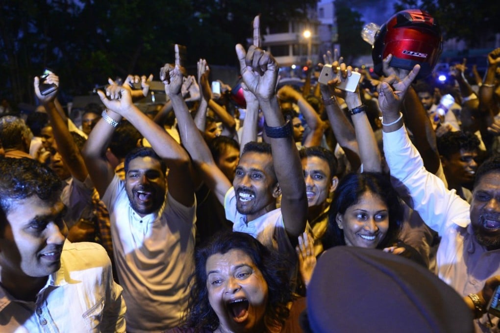 Supporters of Sri Lanka's ousted prime minister Ranil Wickremesinghe celebrate the court’s decision. Photo: AFP