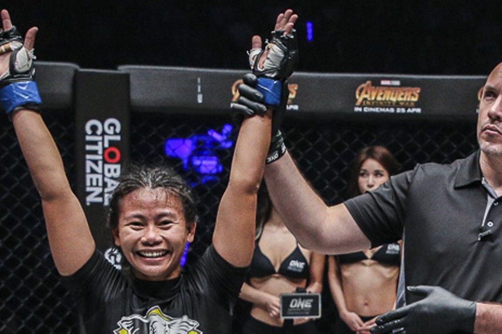 Angelie Sabanal’s arm is raised after beating Rika Ishige in her first MMA fight. Photos: One Championship