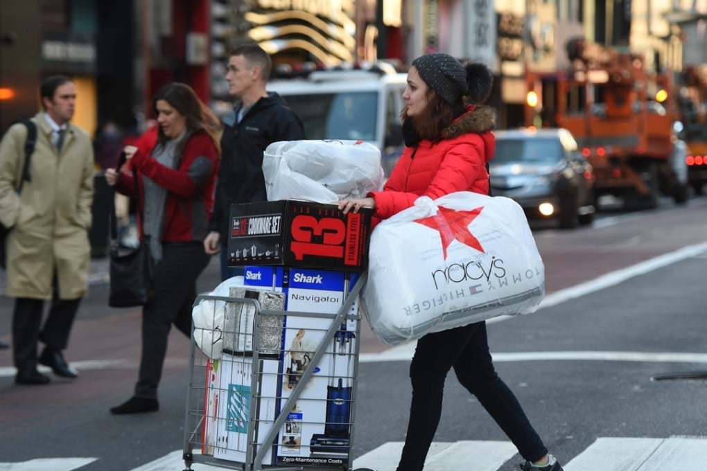 A shopper makes the most of Black Friday sales, the day after Thanksgiving when the Christmas shopping season kicks into high gear, in New York City on November 24, 2017. From shopping dominating traditional festivals to festivals dedicated to shopping, it’s a sign of our consumerist times. Photo: AFP