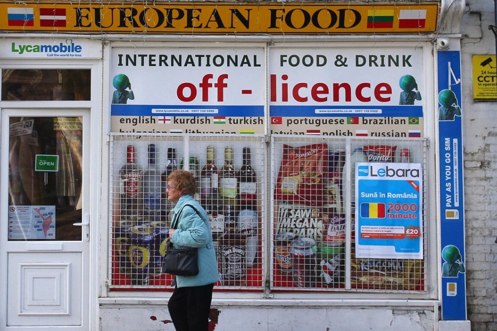 A woman walks past an Eastern European food shop in the market town of Boston in Lincolnshire in eastern England. Photo: AFP