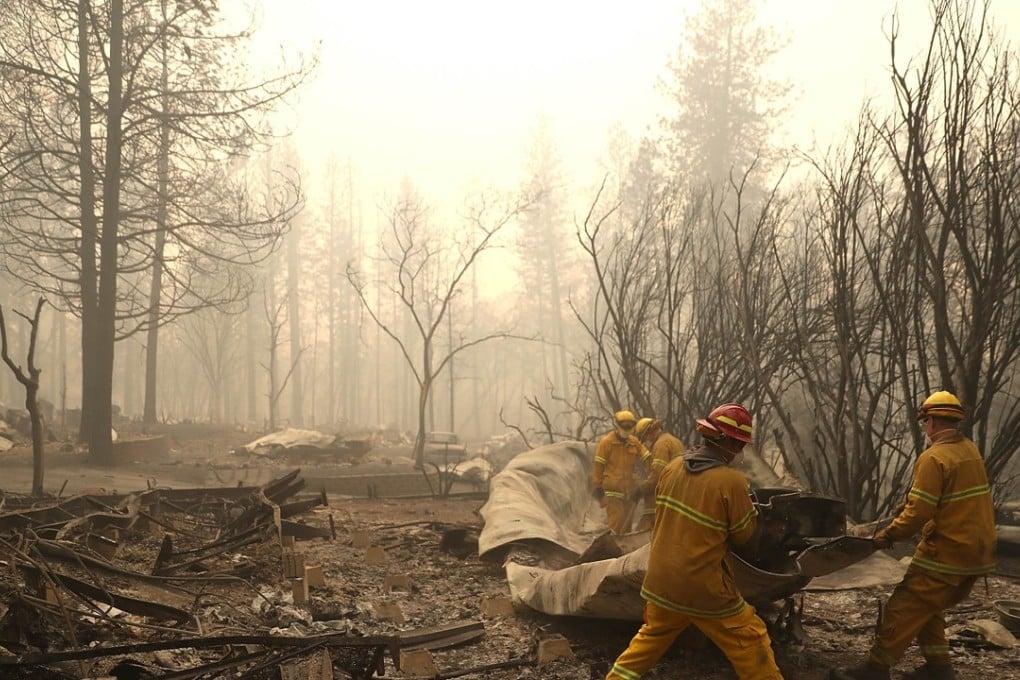 San Francisco firefighters dismantle a burned mobile home as they search for human remains at a mobile home park that was destroyed by the Camp Fire on November 14. Photo: AFP