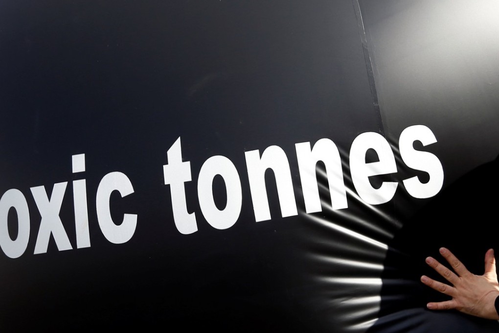 File photo of an environmental activist pushing a giant ball with the words ‘toxic tonnes’ on it during a protest outside the European Parliament in Brussels. Photo: Reuters