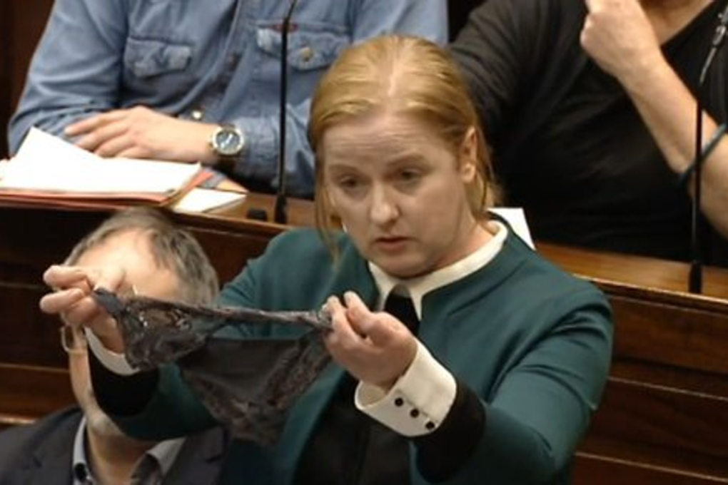 Irish MP Ruth Coppinger brandishes a pair of underwear in the Irish parliament on Tuesday, addressing the furore associated with the #ThisIsNotConsent protest. Photo: Oireachtas TV