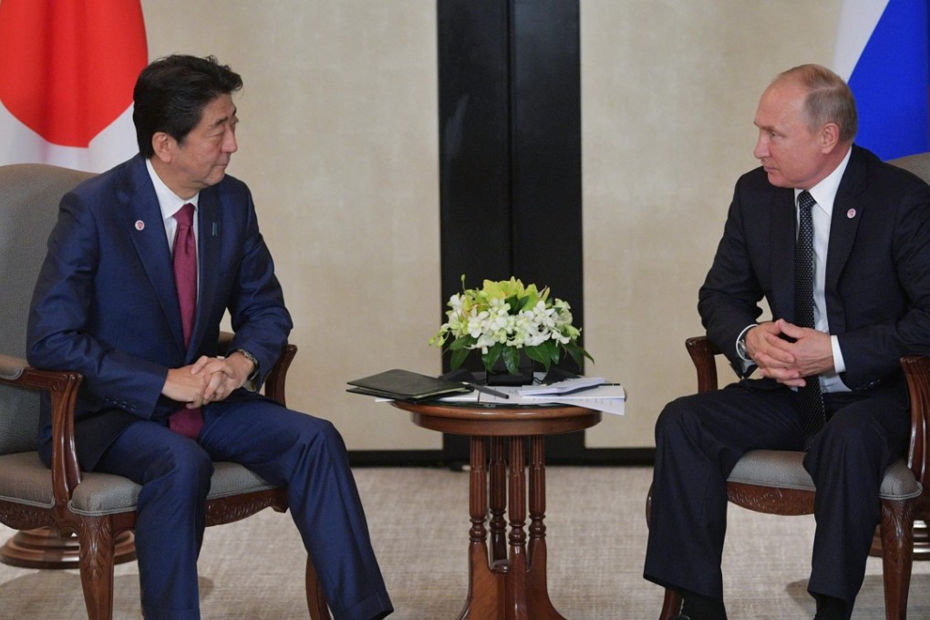 Russian President Vladimir Putin meets with Japanese Prime Minister Shinzo Abe during their meeting on the sidelines of the 33rd Association of Southeast Asian Nations Summit. Photo: EPA