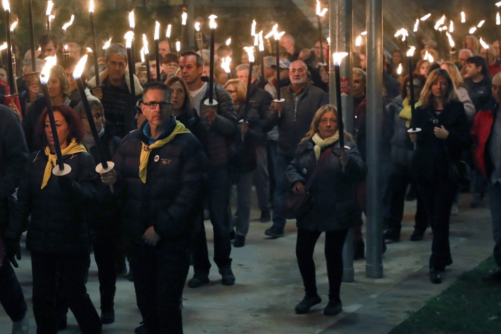 Demonstrators hold a silent protest on the first anniversary of the arrest of former Catalan leaders, at a rally on November 2 in Sant Vicenc dels Horts, near Barcelona. Photo: EPA-EFE