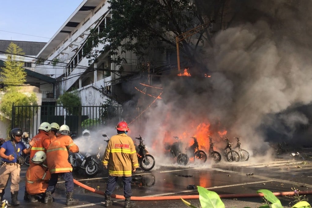 Firefighters battle a blaze during the Surabaya terror attacks in May. Photo: AFP