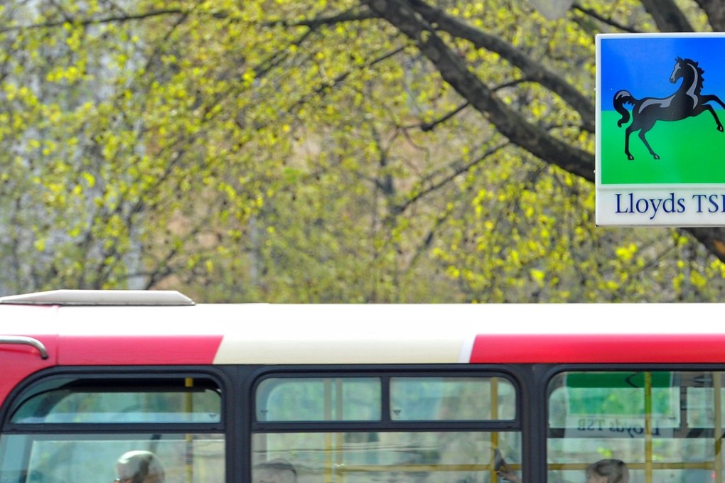 File photo of a London bus passing a branch of Lloyds TSB bank in central London. Photo: Reuters