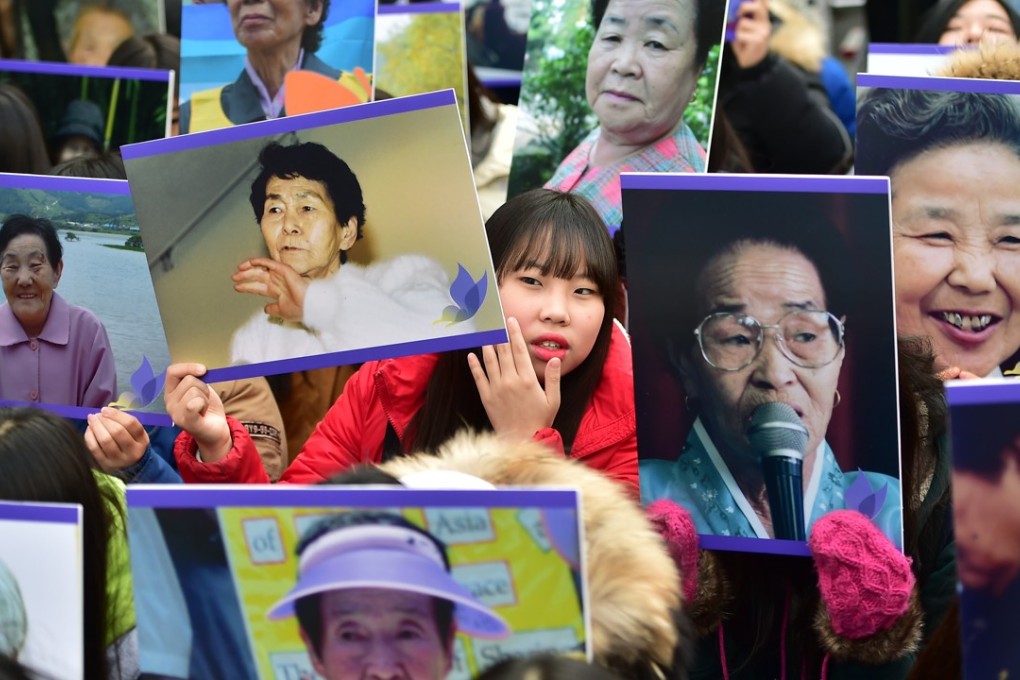 Portraits of former ‘comfort women’ are held aloft at an anti-Japanese rally in Seoul. Photo: AFP