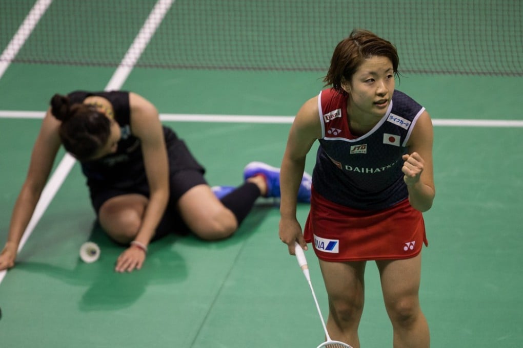 Japan’s Nozomi Okuhara celebrates defeating a vanquished Ratchanok Intanon at the Hong Kong Open. Photo: EPA
