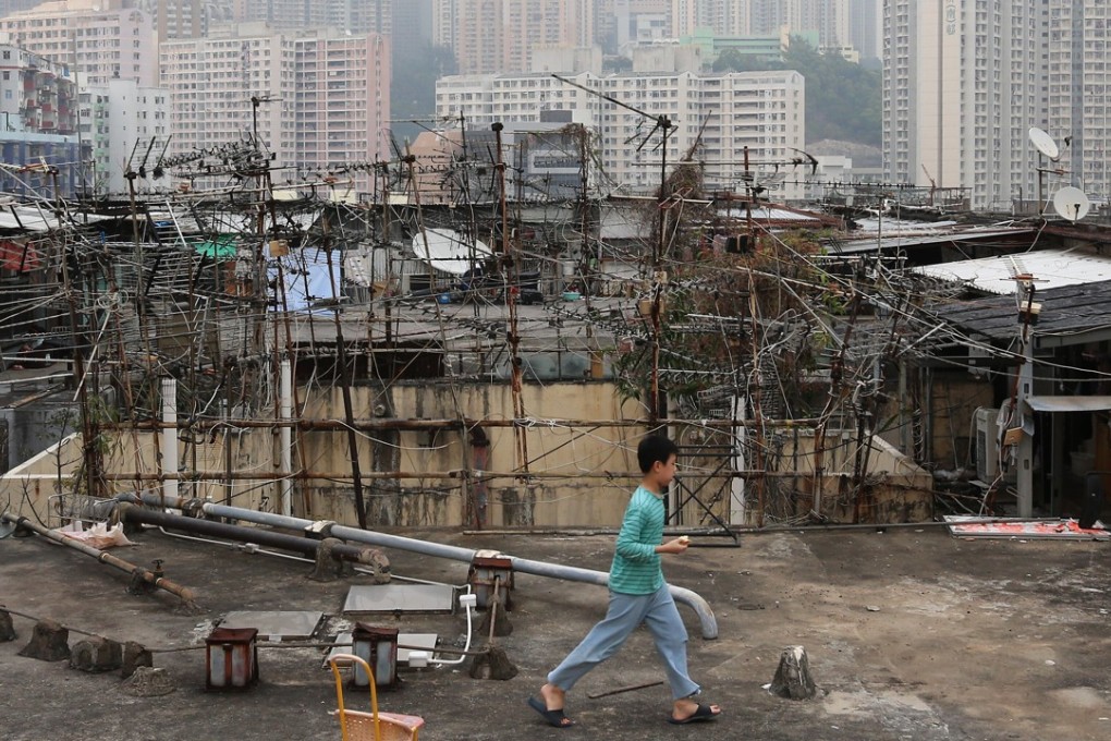 A child outside illegal cubicle homes on the rooftop of an industrial building in Kwun Tong. Photo: Dickson Lee