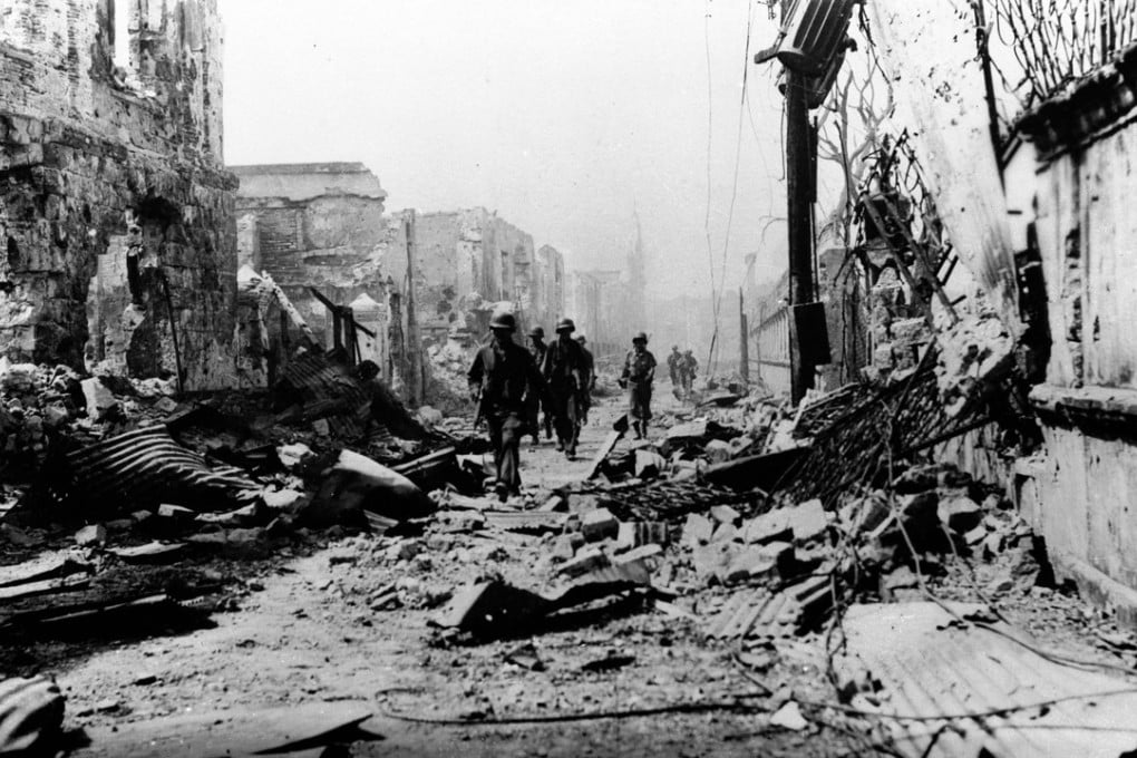 American troops advance through the ruined centre of Manila on February 23, 1945, during the second world war. Photo: Roger-Viollet