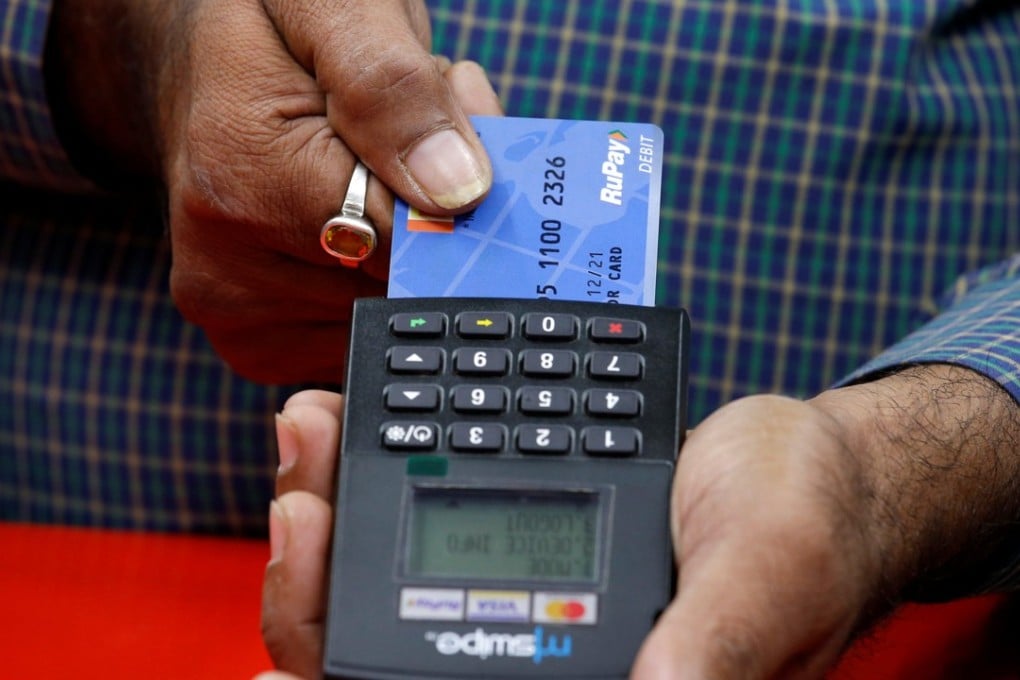 A shopkeeper swipes a customer’s debit card featuring the logo of home-grown Indian payment system RuPay. Photo: Reuters