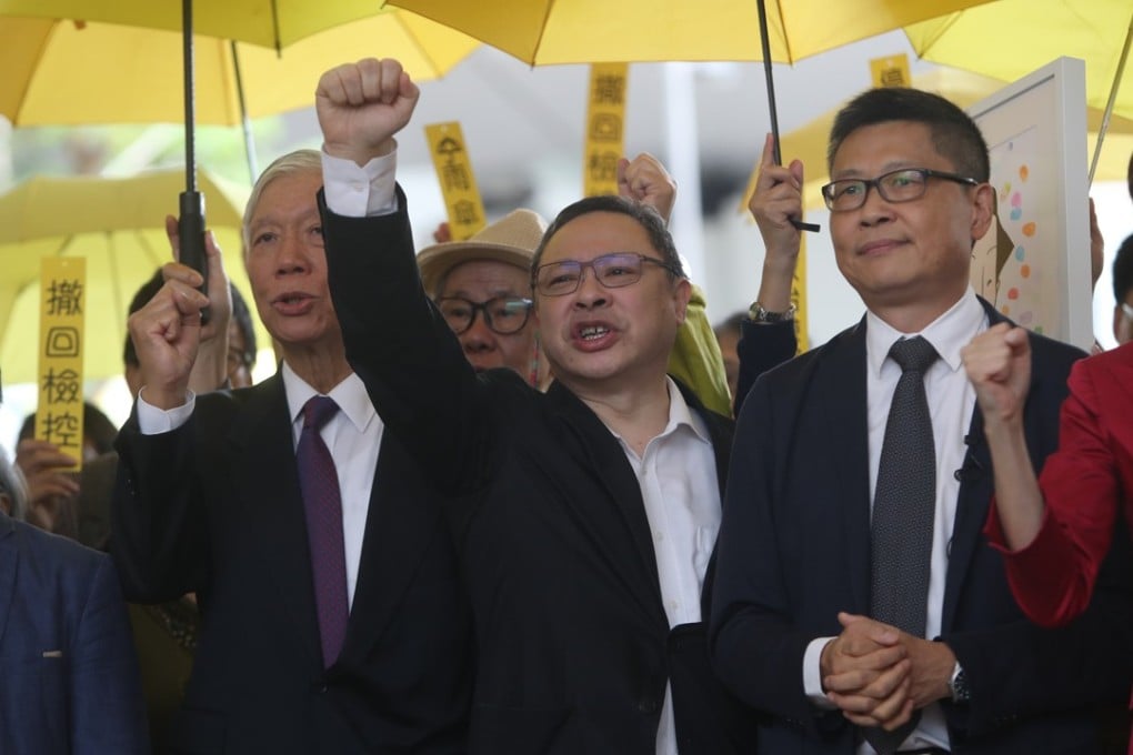 (From second left) Occupy co-founders Reverend Chu Yiu-ming, Benny Tai and Dr Chan Kin-man protest outside West Kowloon Court on Monday morning. Photo: Winson Wong