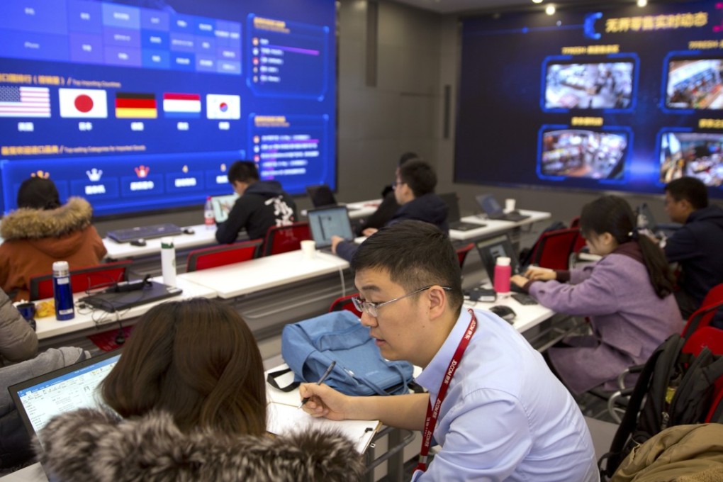 Workers talk as displays show sales data at the command centre at the headquarters of e-commerce company JD.com in Beijing during Singles’ Day on November 11, 2018. Photo: AP