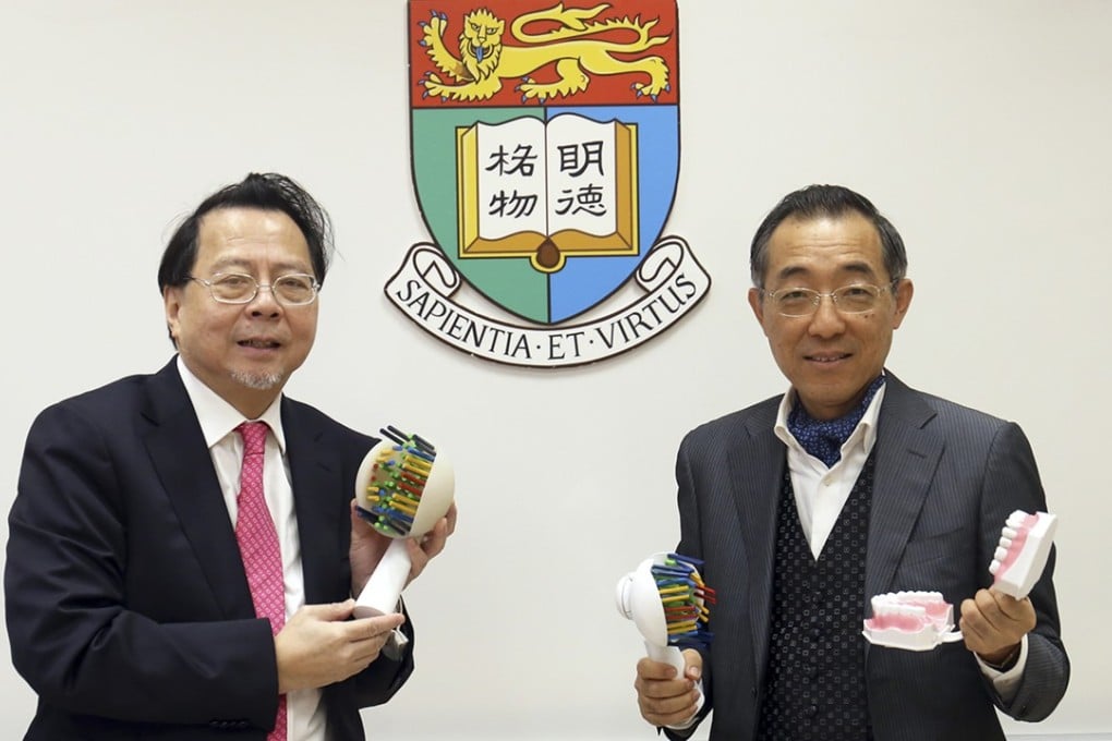 Dr Ng Tze-chuen (left) and Prof Jin Lijian showing enlarged models of their NJ Toothbrush. Photo: Handout