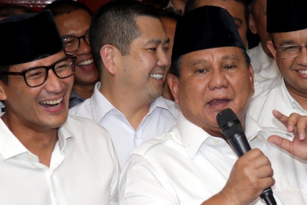 Vice-presidential candidate Sandiaga Uno (left) with his running mate Prabowo Subianto (holding microphone) are taking on President Joko Widodo and his VP Ma’ruf Amin. Photo: EPA