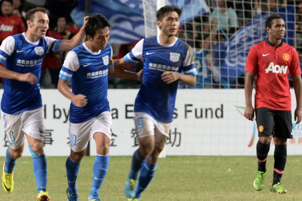 Lam Ka Wai (second right) of Kitchee celebrates with teammates after scoring against Manchester United during their friendly match at Hong Kong Stadium in 2013. Photo: AFP