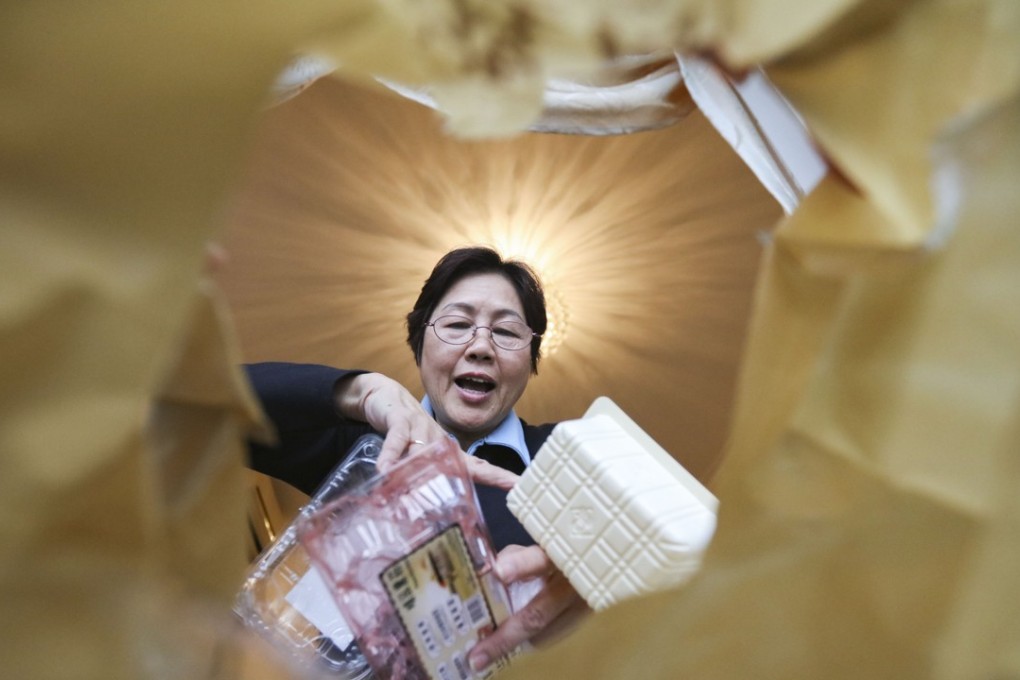 A resident of Lohas Park, Tseung Kwan O, sorts her plastic waste according to government regulations in December 2017. Photo: Felix Wong