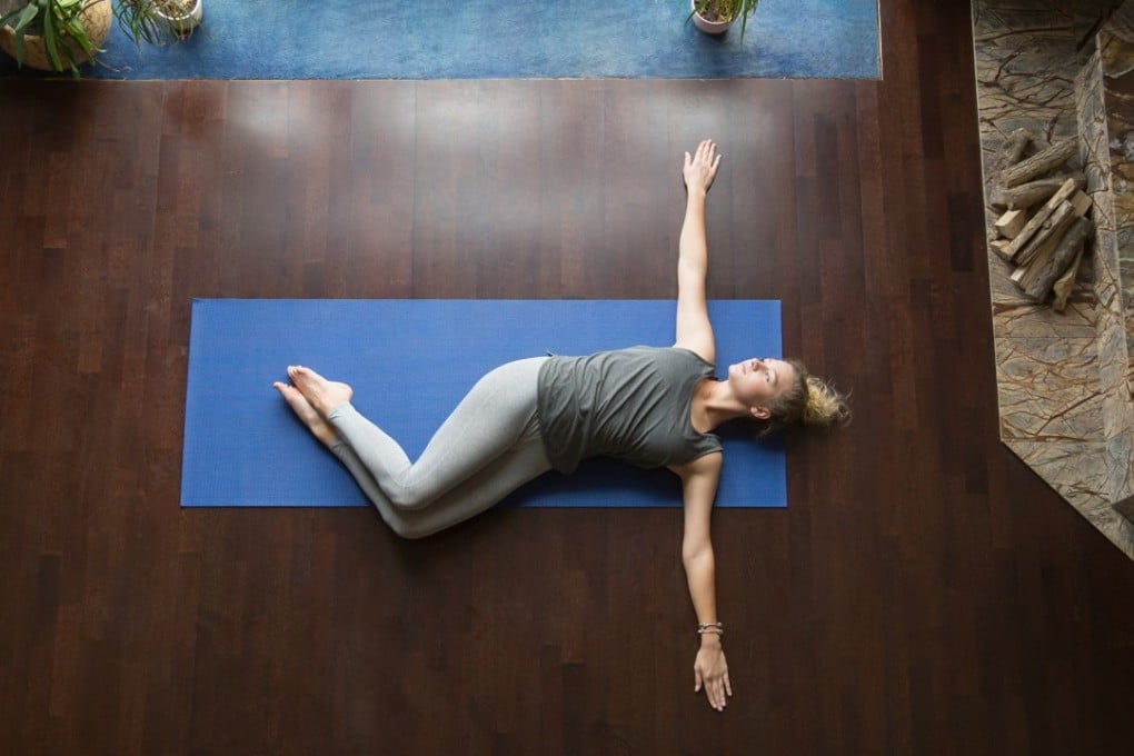 The spinal twist is a recommended stretching exercise that helps keep your spine healthy. Shutterstock