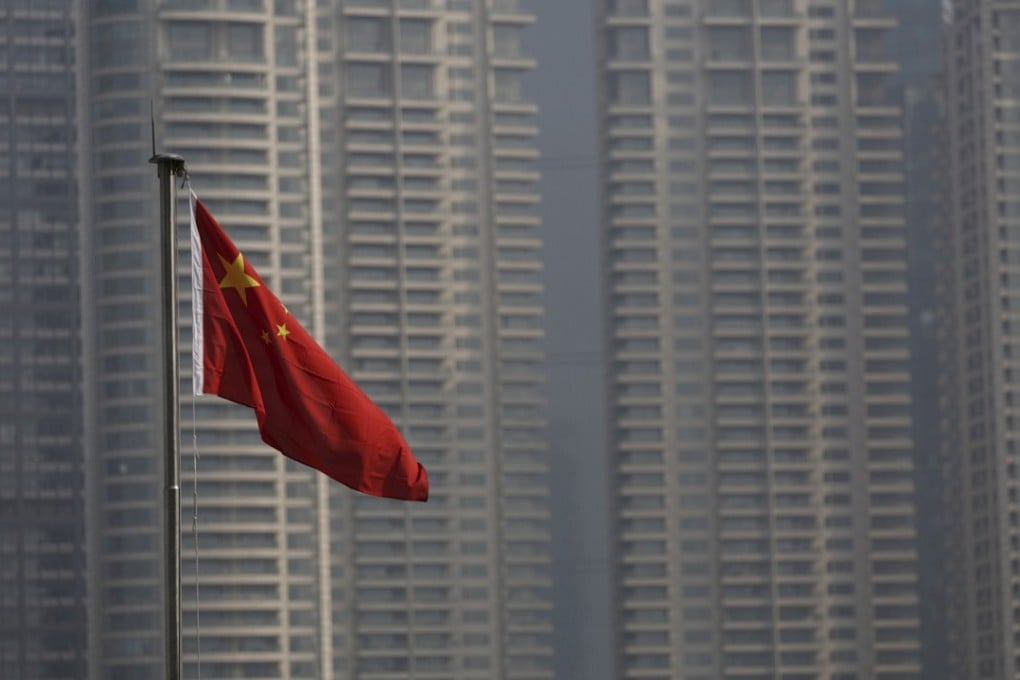 A Chinese flag flies in the financial district of Pudong in Shanghai. By easing restrictions on FDI in China, the government shows it understands that a more level playing field for foreign companies is ultimately beneficial for its own long-term prosperity. Photo: Reuters