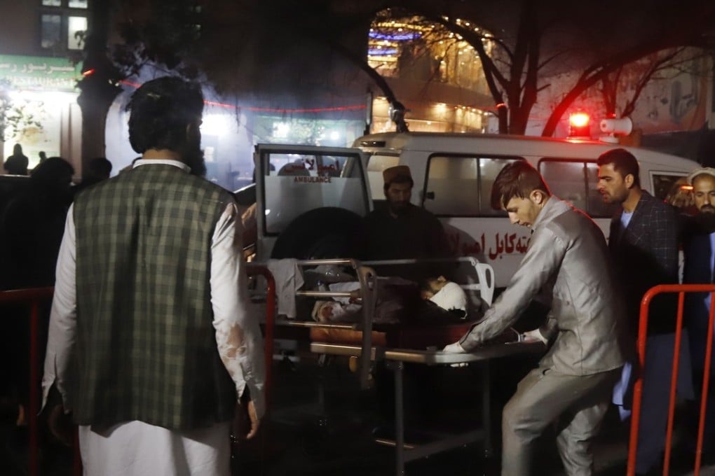 Afghan health workers carry an injured person to an ambulance after a suicide attack targeted a wedding hall in Kabul, Afghanistan on November 20, 2018. Photo: EPA