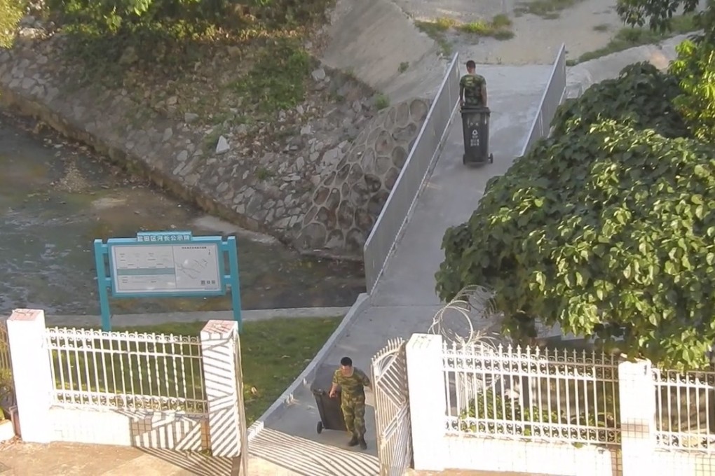 Members of the Guangdong Border Defence Corp cross the bridge linking the garden in Hong Kong with the mainland. Source: Factwire
