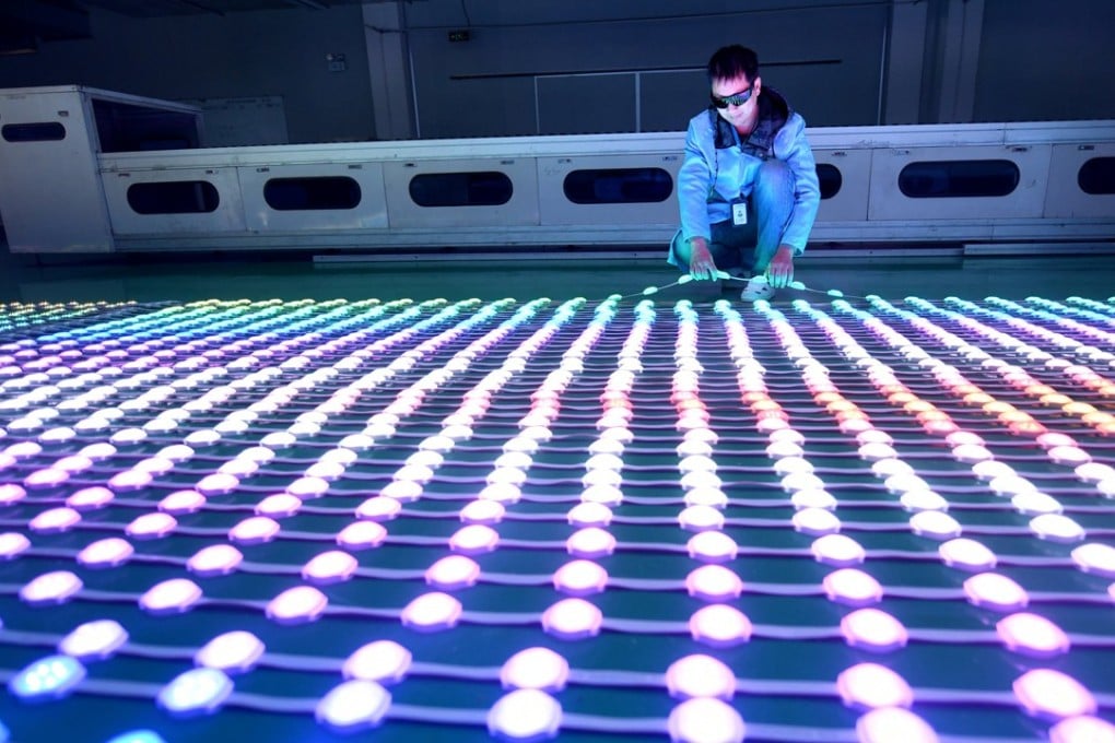 A worker examines LEDs at a manufacturing plant in Haian, Jiangsu province, China. Photo: Reuters