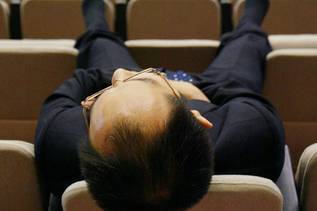 A Japanese businessman takes a nap. Photo: AFP