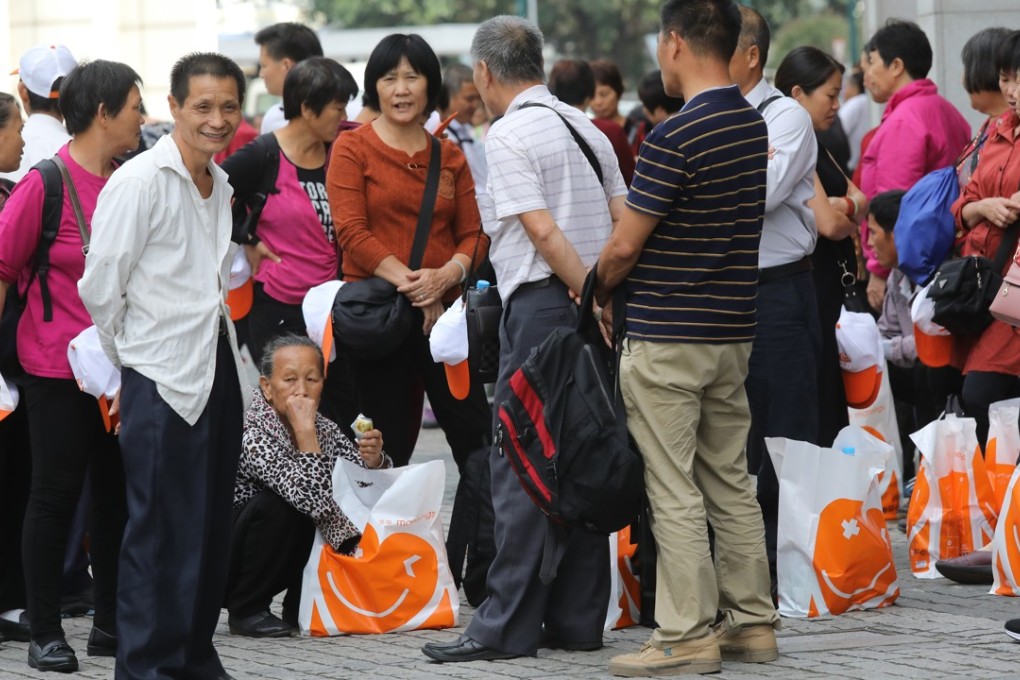Mainland tourists gather after shopping in Tung Chung. Photo: Dickson Lee