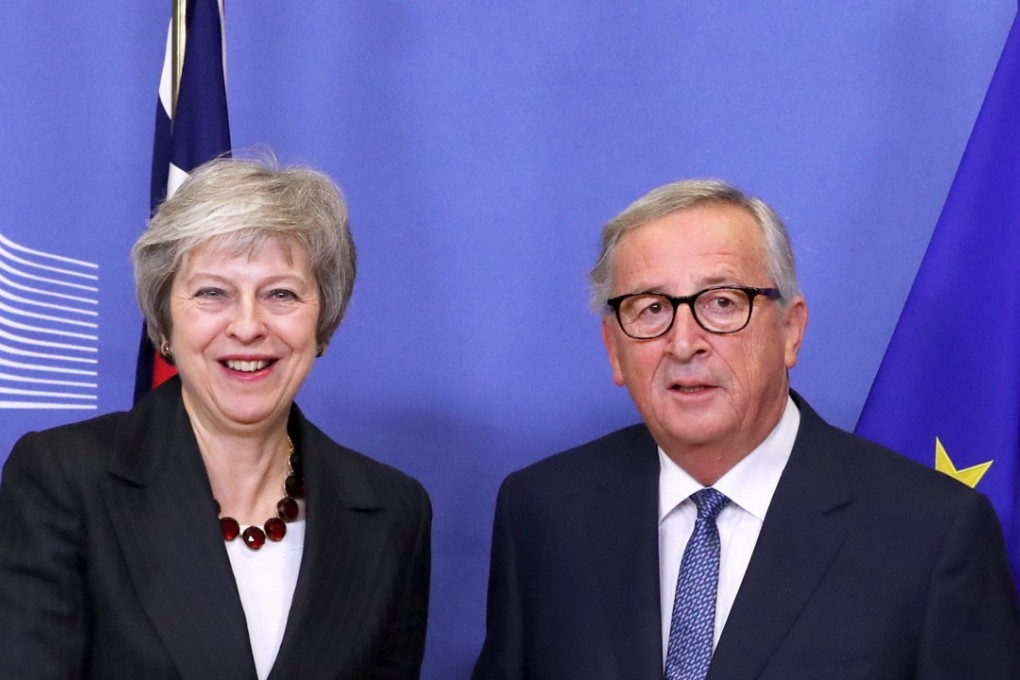 British Prime Minister Theresa May and European Commission President Jean-Claude Juncker shake hands before a meeting to discuss draft agreements on Brexit. Photo: Reuters