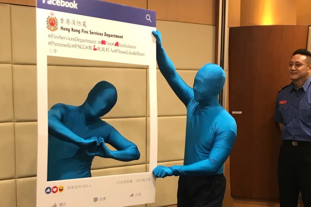 The Fire Services Department mascot Anyone, played by real firefighters dressed in blue bodysuits, appears at the official launch of the department’s Facebook page on November 5. Photo: Christy Leung