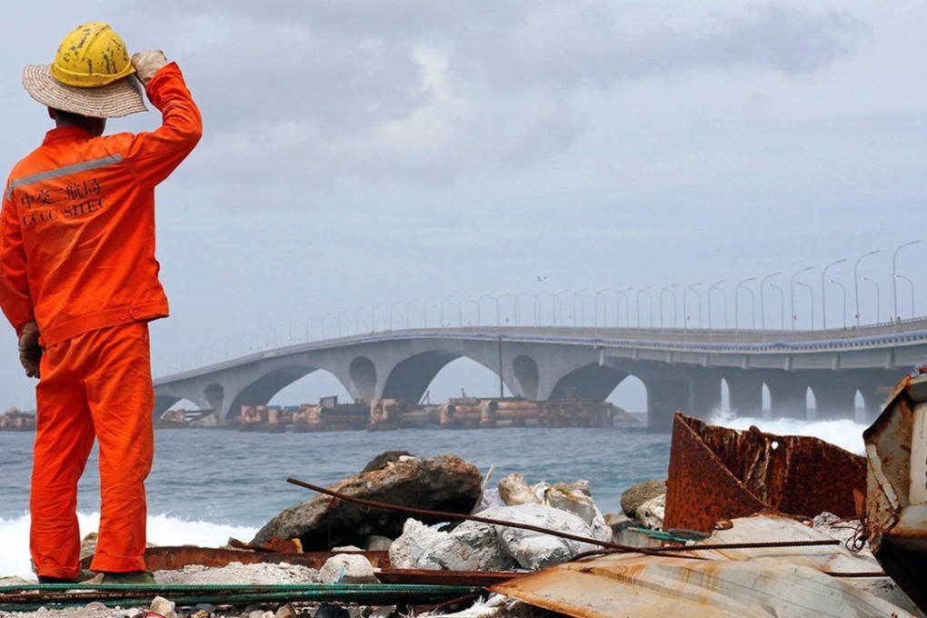 A construction worker looks on at the China-funded Sinamale bridge in the Maldives. Photo: Reuters