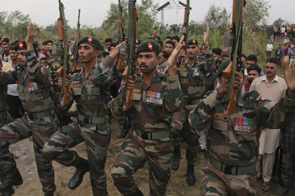 Indian army soldiers pay their respect during the cremation ceremony of a fellow soldier. Photo: AP