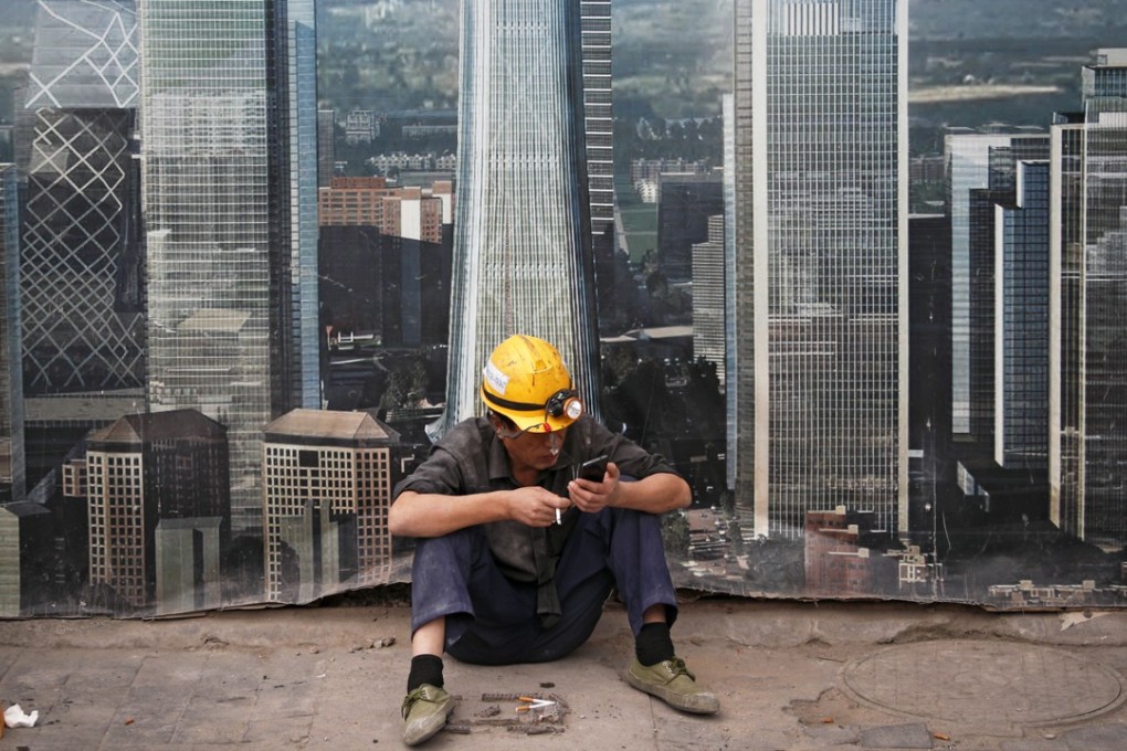 A worker takes a break outside a construction site in Beijing. The US-China trade war is likely to extend into the new year. The potential for further damage should help deter the countries from taking their threats too far. But the uncertainty from the trade tension may lead the world’s business community to consider restructuring global supply chains. Photo: AP