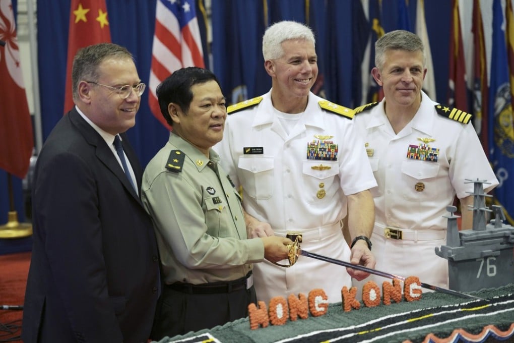 US Consul General Kurt Tong (far left) cuts a cake with He Qimao, chief of staff for the PLA’s Hong Kong garrison, US Rear Admiral Karl Thomas, commander of Task Force 70, and US Captain Patrick Hannifin aboard the USS Ronald Reagan. Photo: Handout
