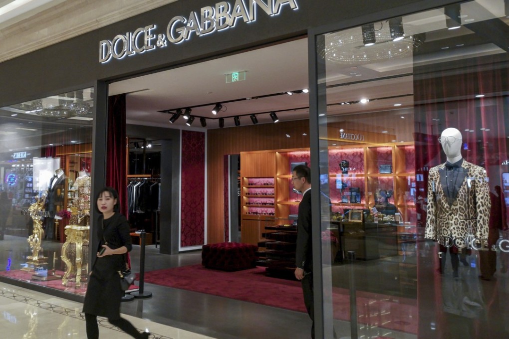 A woman leaves a Dolce & Gabbana in Shanghai on Wednesday, the day the label apologised for insulting remarks co-founder Stefano Gabbana posted on Instagram about critics of the brand’s recent advertising campaign. Photo: (Chinatopix/AP