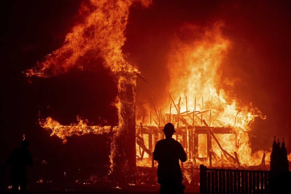 A home burns as the giant wildfire rages through Paradise, California. More than 1,000 people are missing as a result of the blaze. Photo: AP