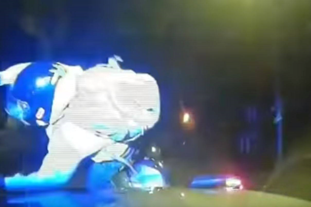 A suspect riding a moped is sent flying after being rammed by a police car, in a scene from a video released by London's Metropolitan Police. Photo: AP