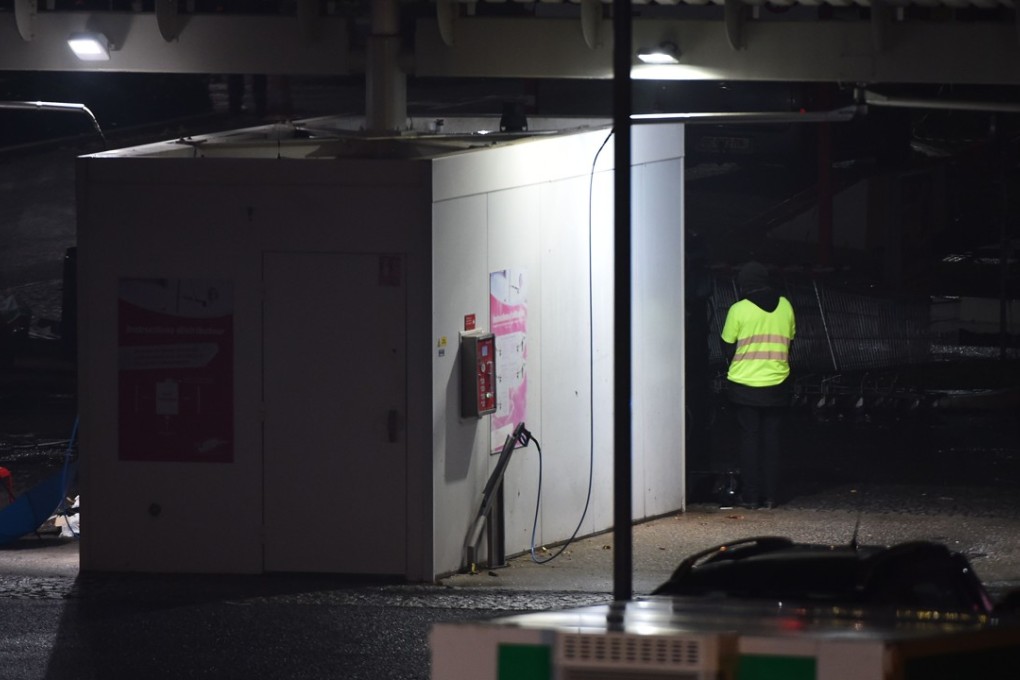 A man wearing a yellow vest and reportedly wielding a grenade at the car wash of a shopping centre in Angers, western France, on November 23, 2018. Photo: AFP