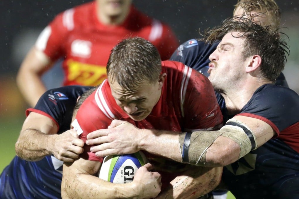 Canada’s Ben Lesage is tackled by Hong Kong captain Jamie Cunningham during the final game of the repechage in Marseille. Photo: AP