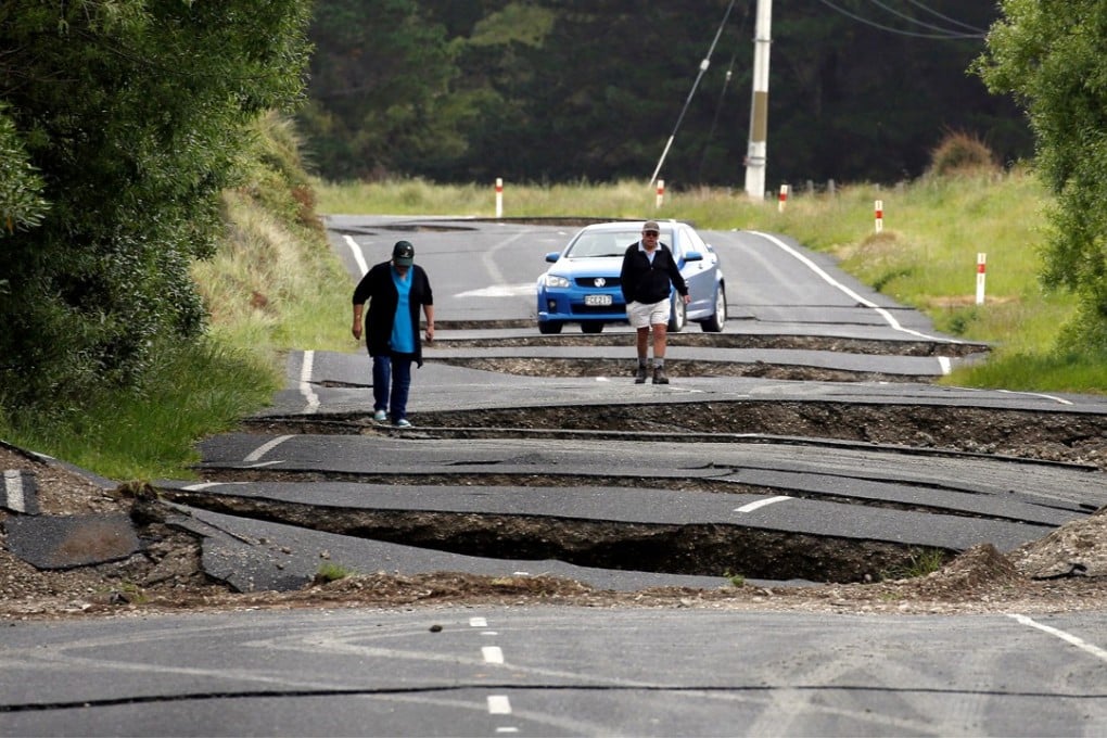 Locals look at damage caused by an earthquake on State Highway One near the town of Ward, south of Blenheim on New Zealand’s South Island on November 14, 2016. Photo: Reuters