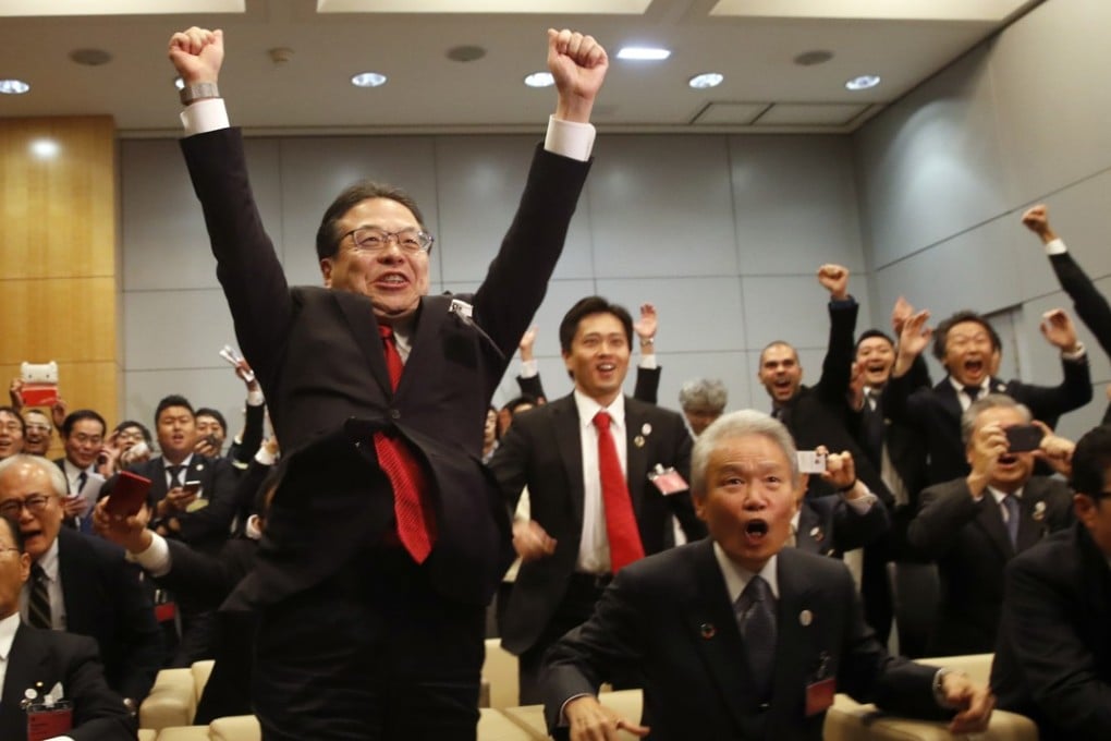Japan's Economy, Trade and Industry Minister Hiroshige Seko jumps for joy in Paris on Friday after Osaka was announced as the winning bidder for the 2025 World Expo. Photo: AP