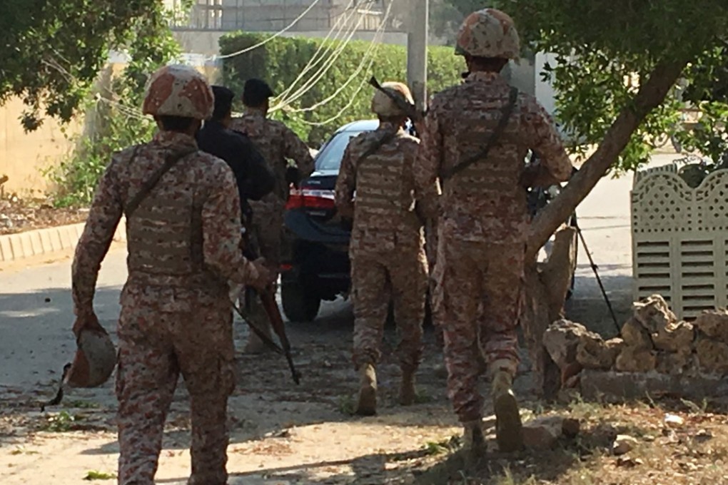 Paramilitary forces and police are seen during an attack on the Chinese consulate, where blasts and shots were heard, in Karachi. Photo: Reuters