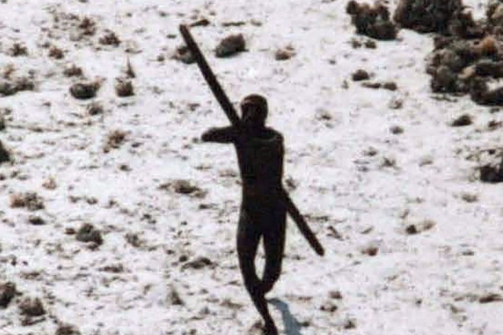A Sentinelese tribesman takes aim with his bow at an Indian Coast Guard helicopter as it flies over North Sentinel Island in 2004. Members of one of the world's last tribes untouched by modern civilisation have killed an American who ventured illegally onto their remote island, Indian police have said. Photo: AFP / Indian Coast Guard / Survival International